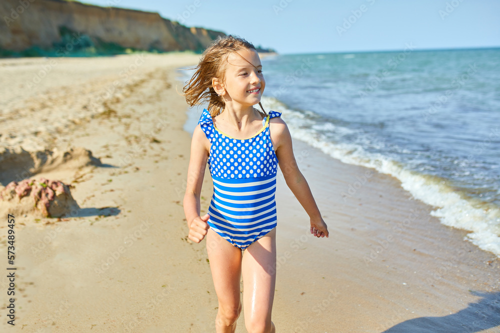Happy, joyful little girl run on the beach Happy, joyful little girl run on the beach