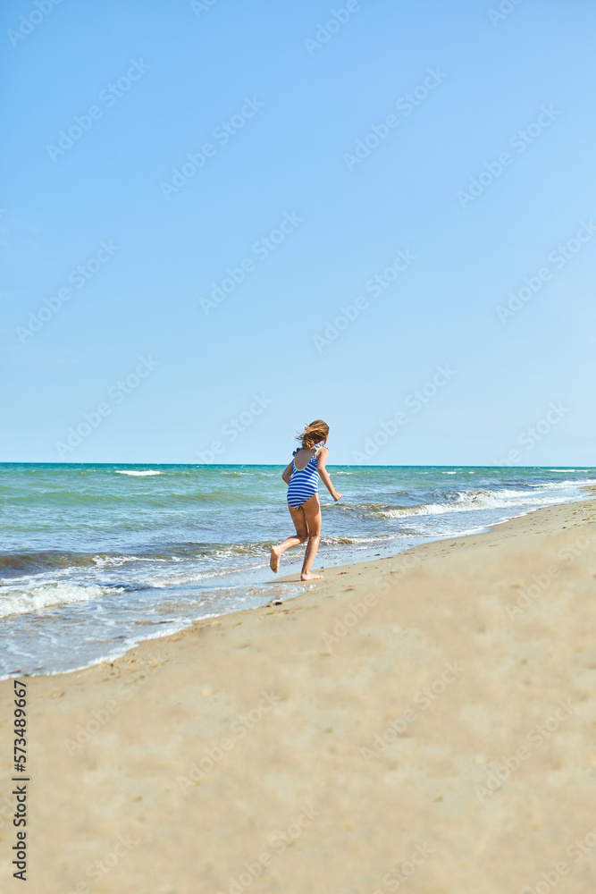 Happy, joyful little girl run on the beach Happy, joyful little girl run on the beach