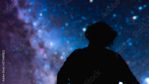 Silhouette of a woman with Milky Way starry skies.