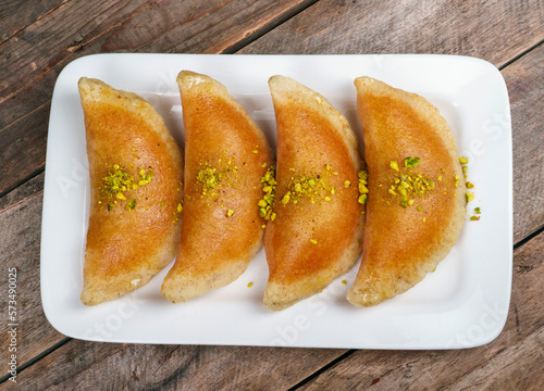 Qatayef, Traditional Arabic Ramadan Sweets on plate.Top view photo