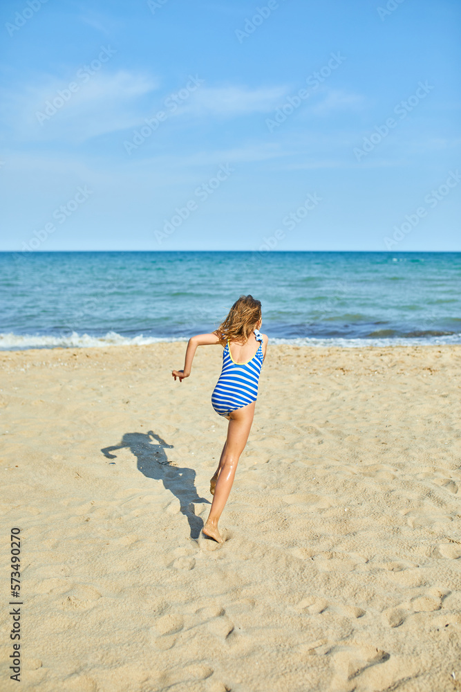 Happy, joyful little girl run on the beach Happy, joyful little girl run on the beach