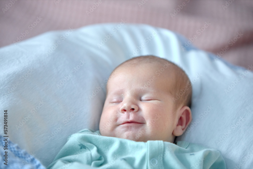 the newborn boy is sleeping. cute beautiful baby is sleeping closeup portrait of a beautiful sleeping baby on white. the newborn boy is sleeping. cute beautiful baby is sleeping closeup portrait of a beautiful sleeping baby on white.