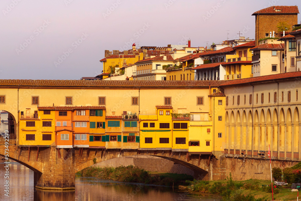 Ponte Vecchio and Vasari Corridor in Florence, Tuscany, Italy and reflection in the river Arno