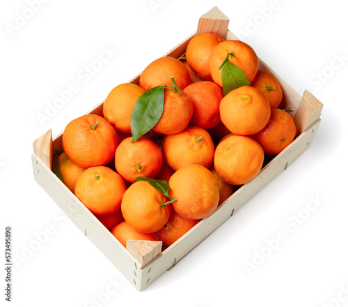 Orange tangerines with green leaves in box. Top view. Isolated on white background