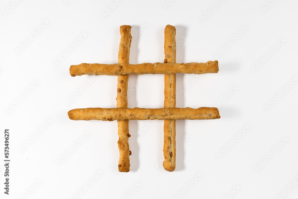 Breadsticks in shape of lattice against white background