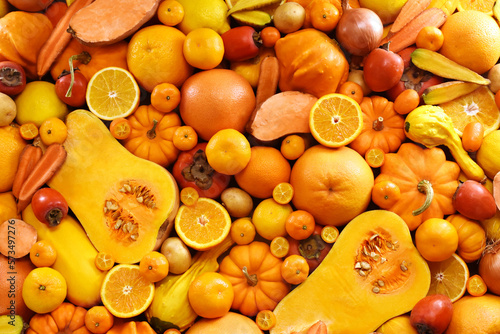 Healthy orange and yellow food high in carotene, fresh ripe bright colorful fruits and vegetables from market, summer farm harvest background