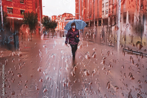 pedestian with an umbrella in rainy days in Bilbao city, spain photo