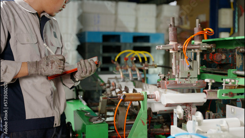 the technician repairing the machine in the factory