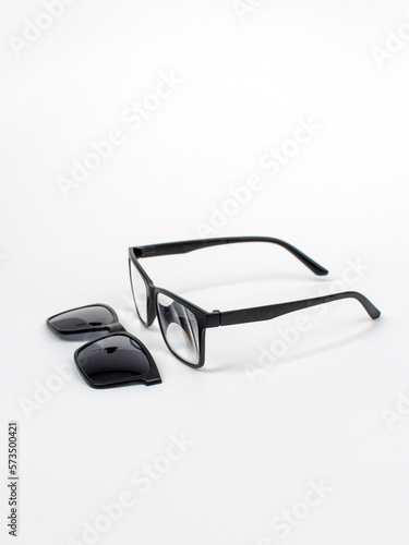 Glasses transformers 2in1 with a magnet. Glasses for computer work. Reading glasses on a white background. Square Black Frame Sunglasses, isolated. Studio shot photo