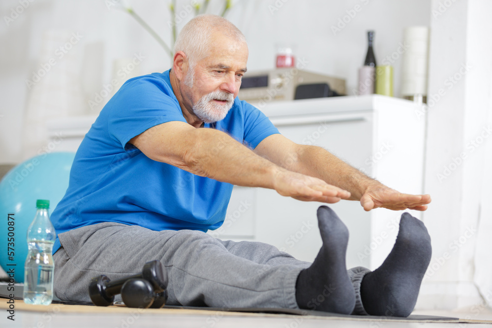 Fototapeta premium senior man is stretching his legs