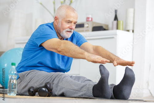 senior man is stretching his legs