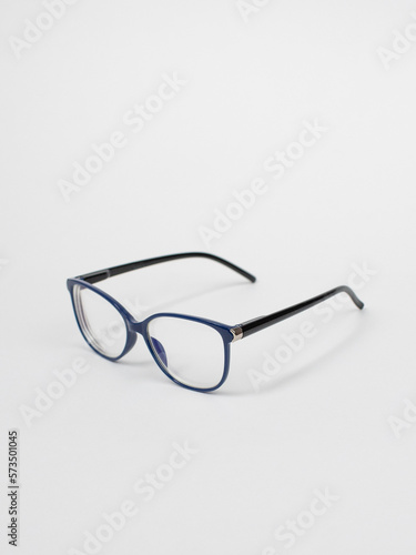 Blue and black rimmed glasses on a white background side view. Isolated object. Glasses for vision