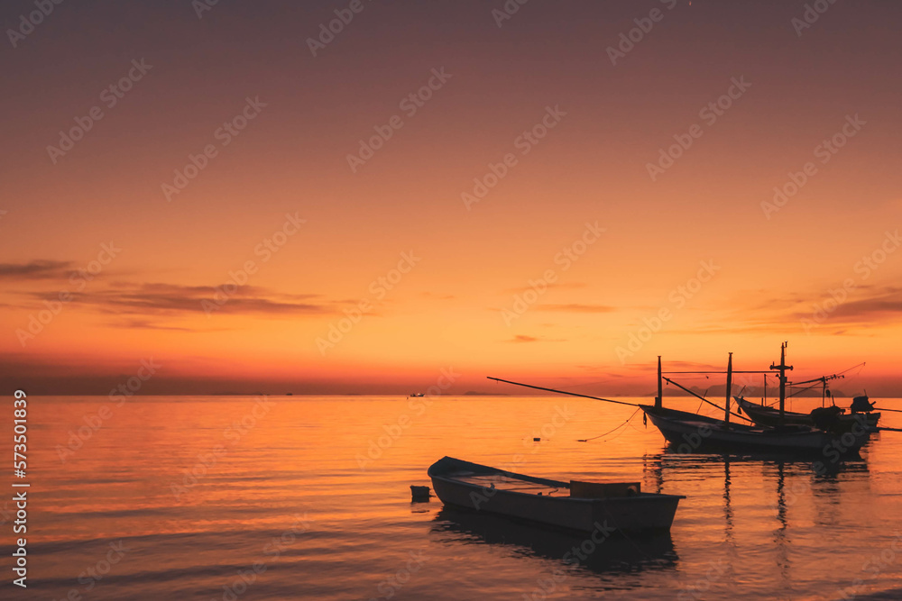 Fisherman boats at the sunset sky
