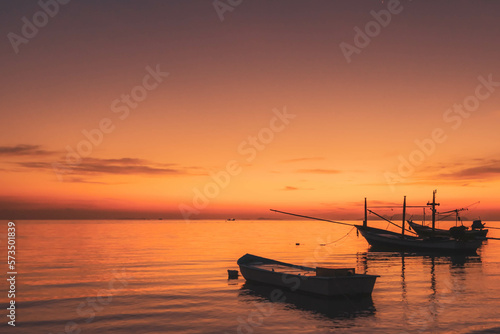 Fisherman boats at the sunset sky