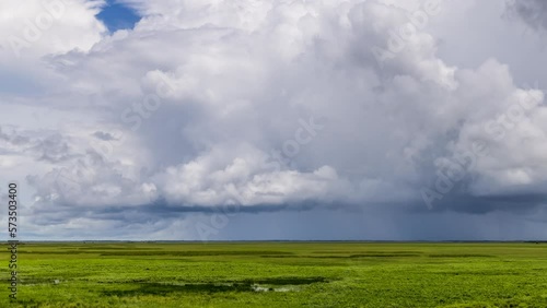 Timelapse of fast moving storm clouds over wetlands in the northern territory during the wet season photo