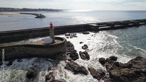 Aerial circle drone view of the Beautiful lighthouse Farolim de Felgueiras in Porto city, Portugal, Atlantic Ocean