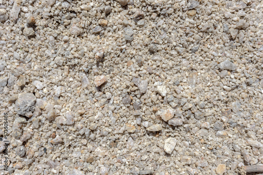 Detail of surface texture with small pebble rock on dirty ground Detail of surface texture with small pebble rock on dirty ground