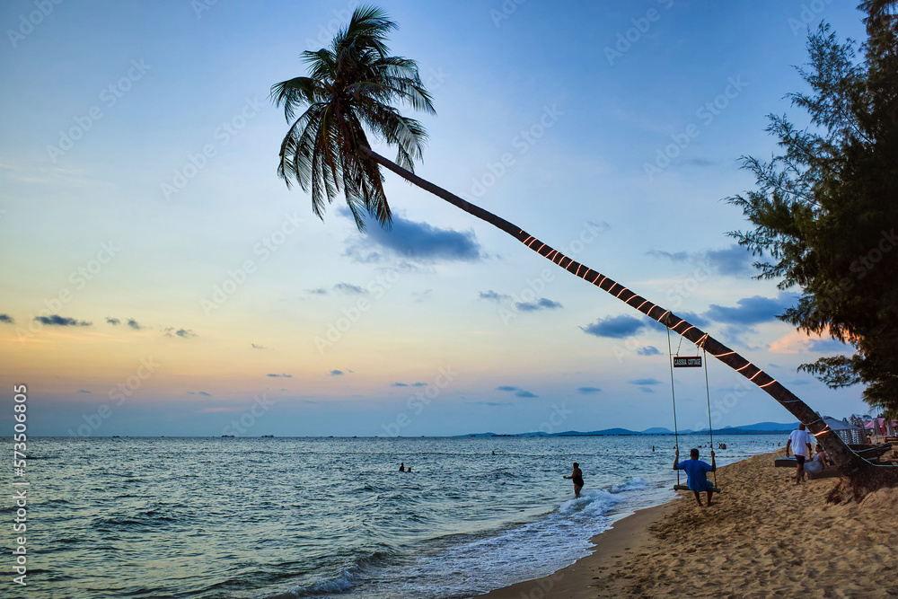 Phu Quoc island, Vietnam - March 30, 2019: Swing on a palm tree. Sea beach at sunset. Spa Romance