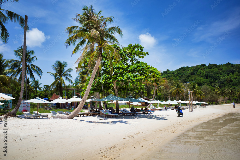 Phu Quoc island, Vietnam - March 31, 2019: A beach of white sand, equipped with sun loungers and umbrellas for relaxing. Beautiful coast of the South China Sea
