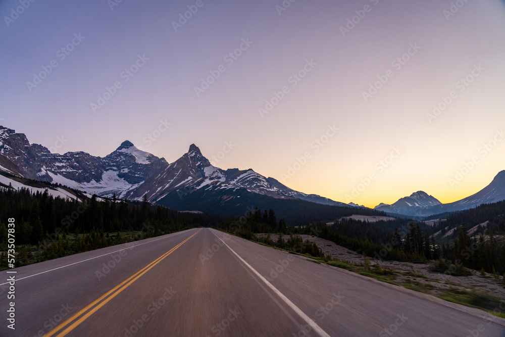 Naklejka premium Driving on Icefields Parkway at twilight time. Alberta Highway 93. Jasper National Park, Canada.