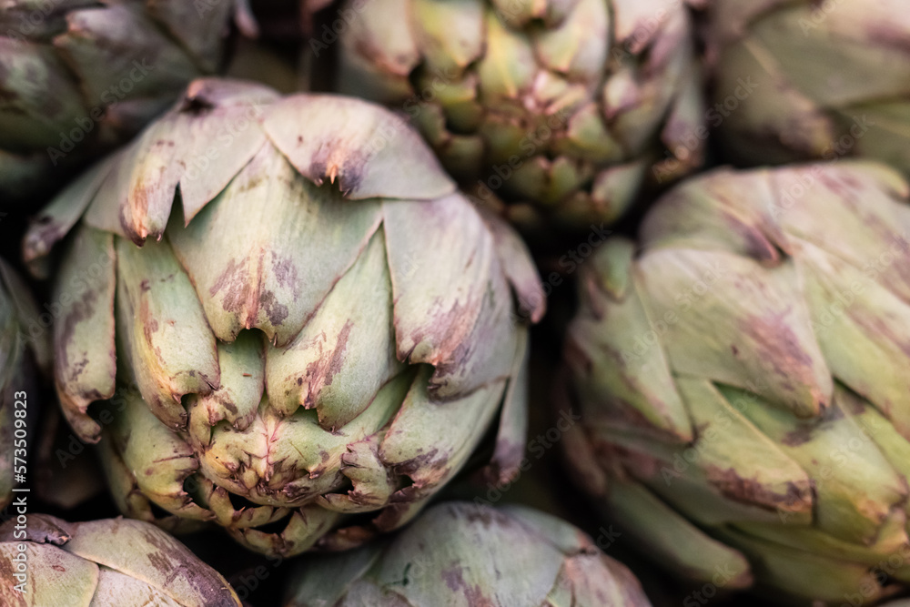 Close-up of bunch of fresh artichokes in the market top view, vegetable background. Close-up of bunch of fresh artichokes in the market top view, vegetable background.
