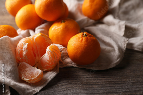 Many fresh ripe tangerines on wooden table, closeup