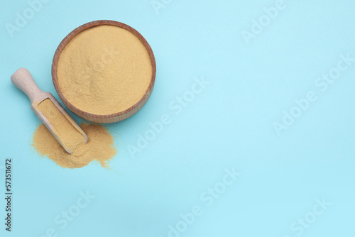Beer yeast powder on light blue background, flat lay. Space for text