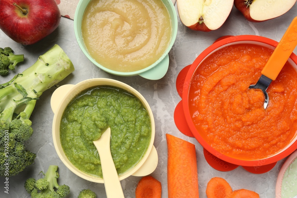 Healthy baby food. Different tasty puree in bowls on light grey marble table, flat lay - obrazy, fototapety, plakaty 