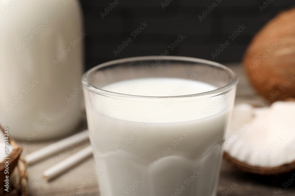 Glass of fresh coconut milk on table, closeup Glass of fresh coconut milk on table, closeup