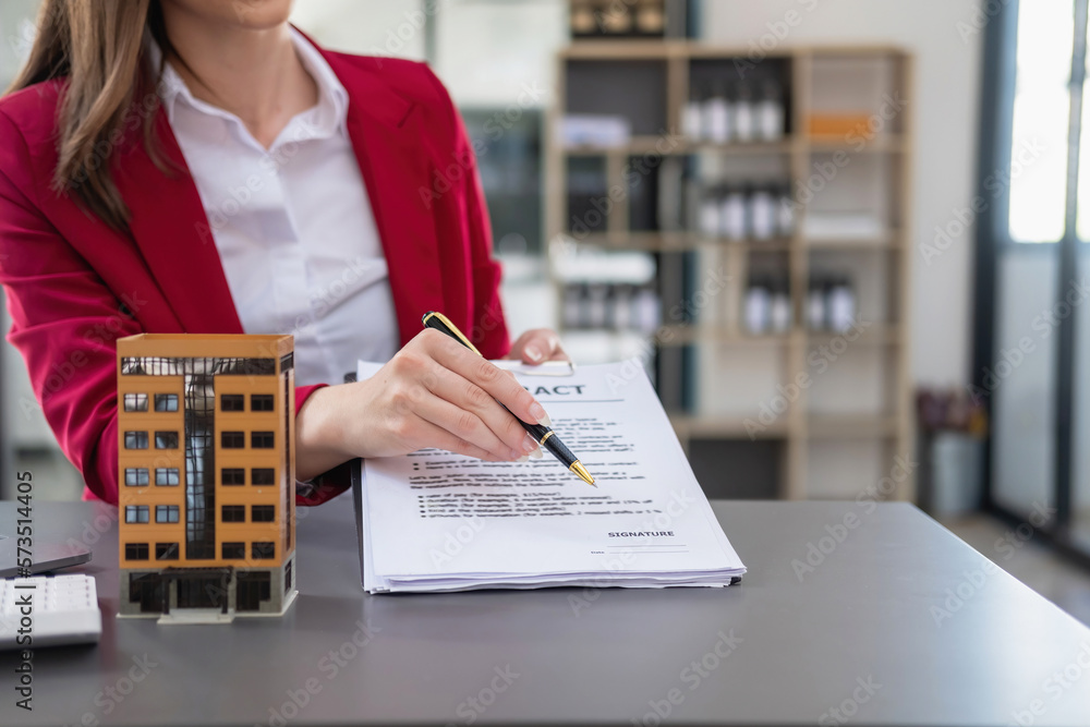 Accountant, businessman, real estate agent, Businessman handing model house to customers along with house interest calculation documents for customers to sign. Accountant, businessman, real estate agent, Businessman handing model house to customers along with house interest calculation documents for customers to sign.
