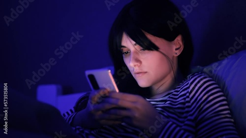 Addicted woman scrolling on smartphone find incredible news promotion sale and extremely happy take credit card for making order buy product online shopping immediately at late dark night Insomnia