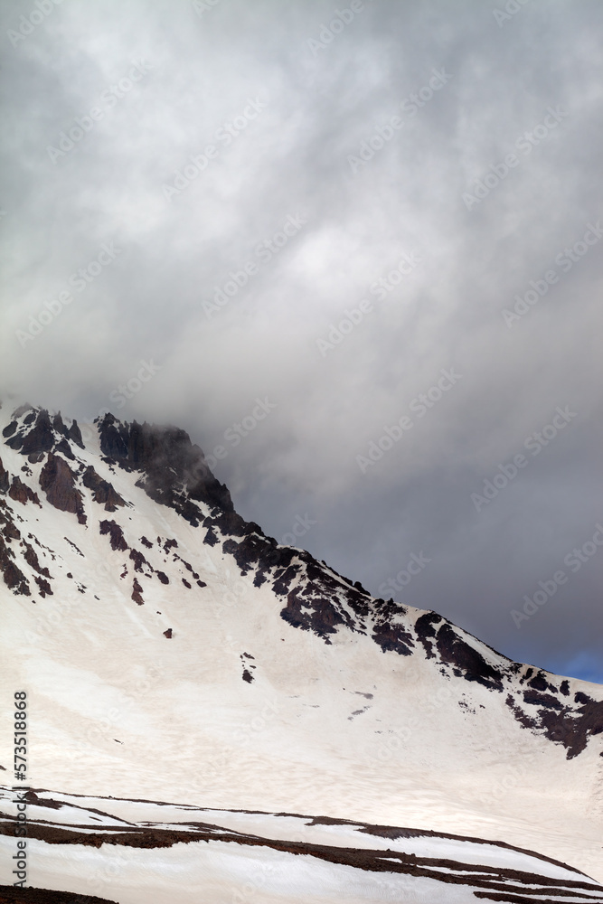 Snowy mountains in storm clouds