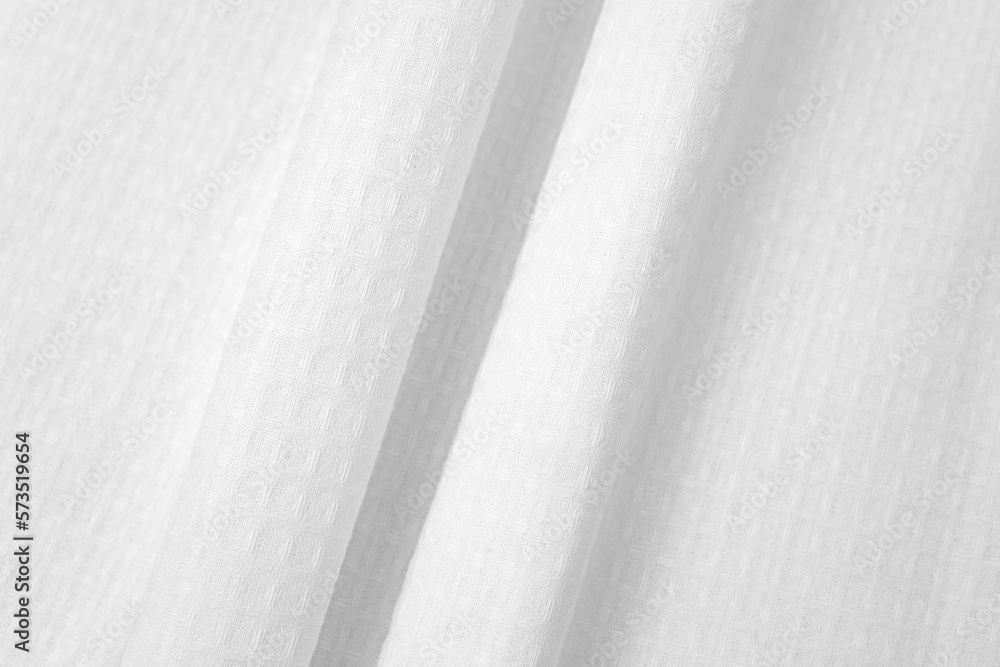 Obraz premium White textured cotton fabrics swatches on light background. Layered Textile Mockup