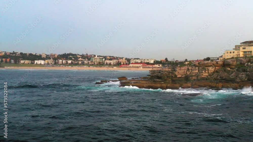 Drone flying over the rocks in North Bondi towards the beach, Sydney Australia Drone flying over the rocks in North Bondi towards the beach, Sydney Australia