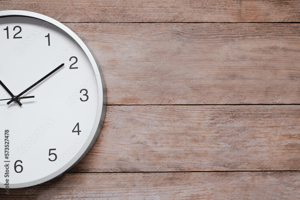 Stylish round clock on wooden table, top view with space for text. Interior element Stylish round clock on wooden table, top view with space for text. Interior element