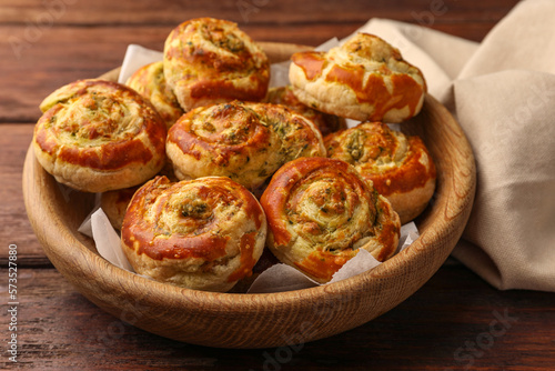Fresh delicious puff pastry with tasty filling on wooden table, closeup