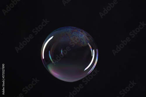 One beautiful soap bubble on black background