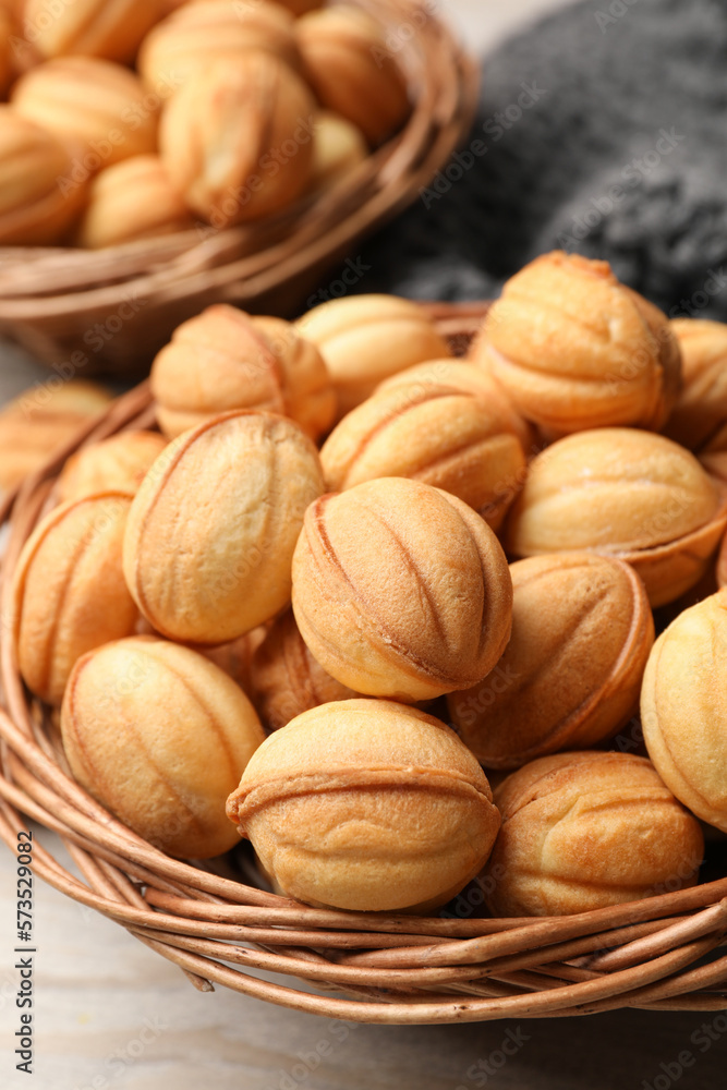 Bowls of delicious nut shaped cookies on white wooden table, closeup Bowls of delicious nut shaped cookies on white wooden table, closeup