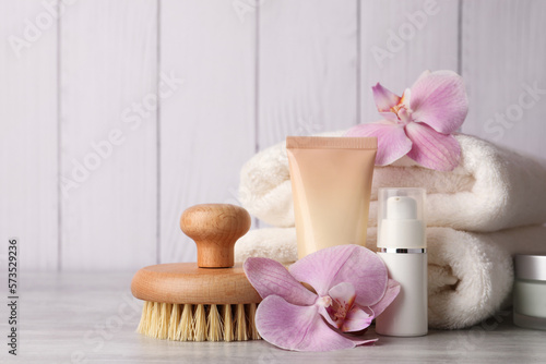 Beautiful composition with different spa products on light gray table. Space for text