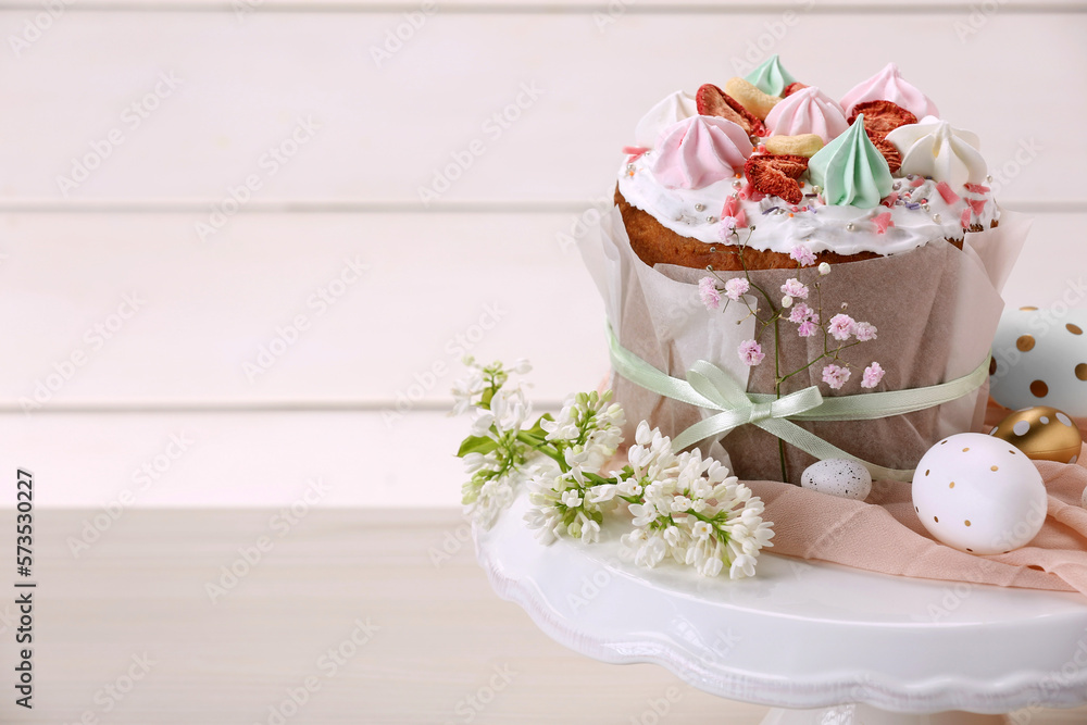 Traditional Easter cake with meringues and painted eggs on white wooden table, space for text Traditional Easter cake with meringues and painted eggs on white wooden table, space for text