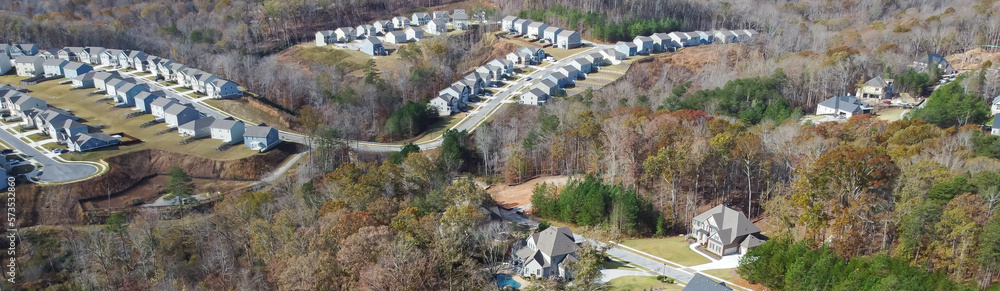 Fototapeta premium Panorama view row of new developments houses in master planned subdivision with lush green trees and natural trails outside Atlanta, Georgia, US