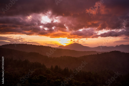 Sunset over misty hills