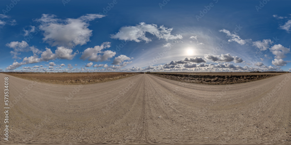 spherical 360 hdri panorama on gravel road with clouds on blue sky with halo in equirectangular seamless projection, use as sky replacement in drone panoramas, game development as sky dome