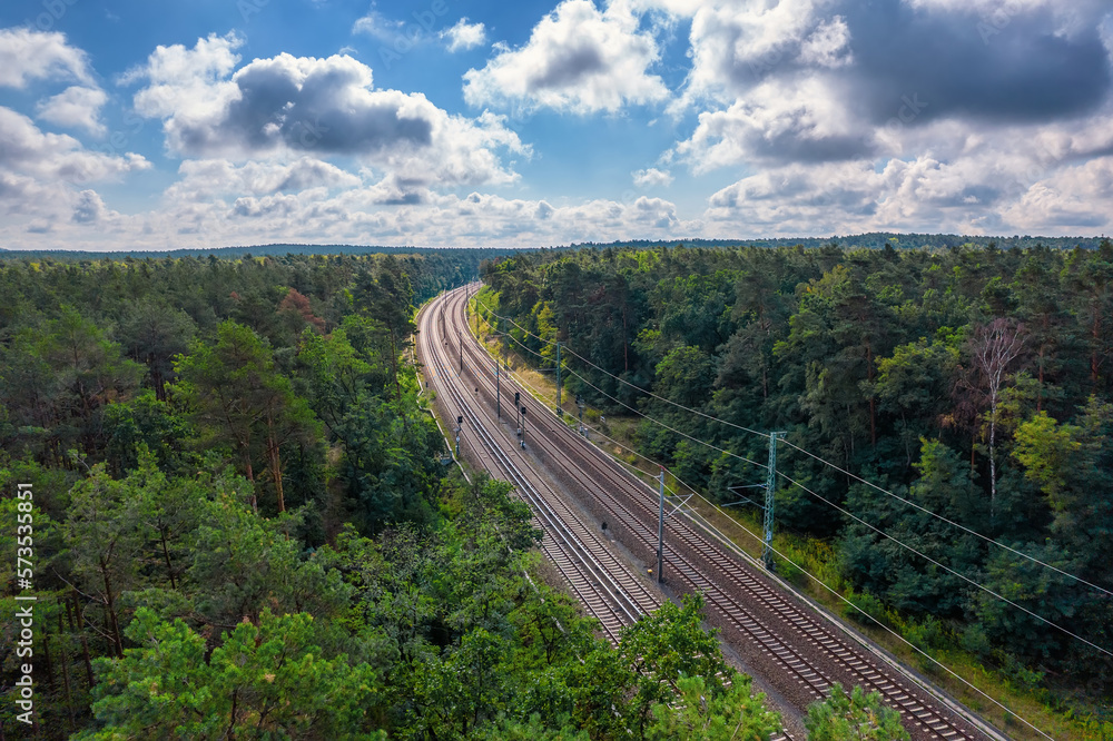 Railway through summer forest, aerial view. Railway through summer forest, aerial view.