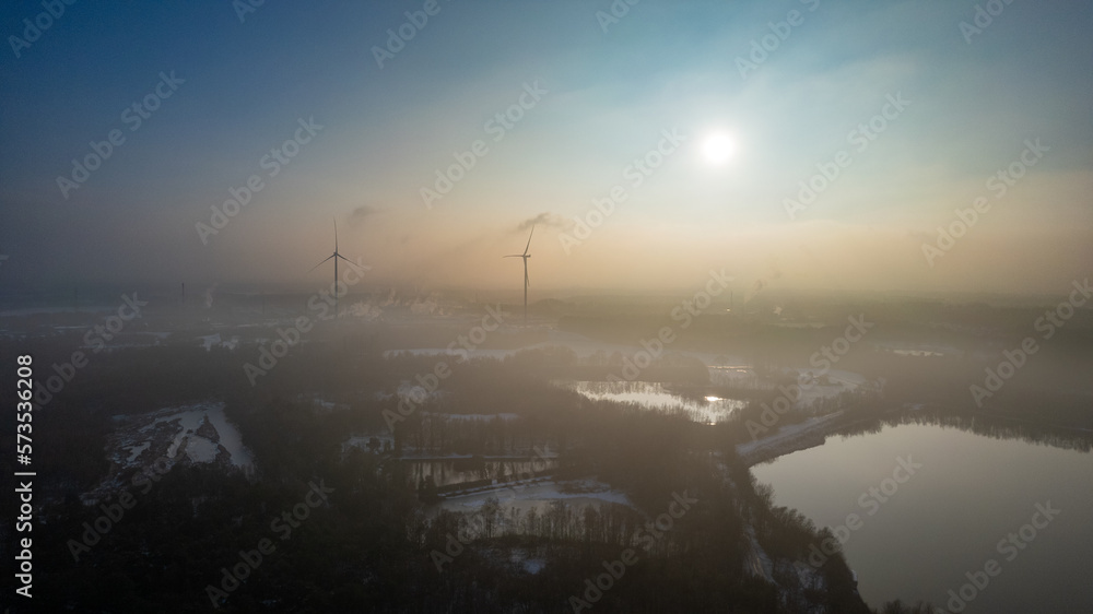 Aerial landscape of the frozen lake and forest in the snow in Belgium at sunset shot by a drone. High quality photo Aerial landscape of the frozen lake and forest in the snow in Belgium at sunset shot by a drone. High quality photo