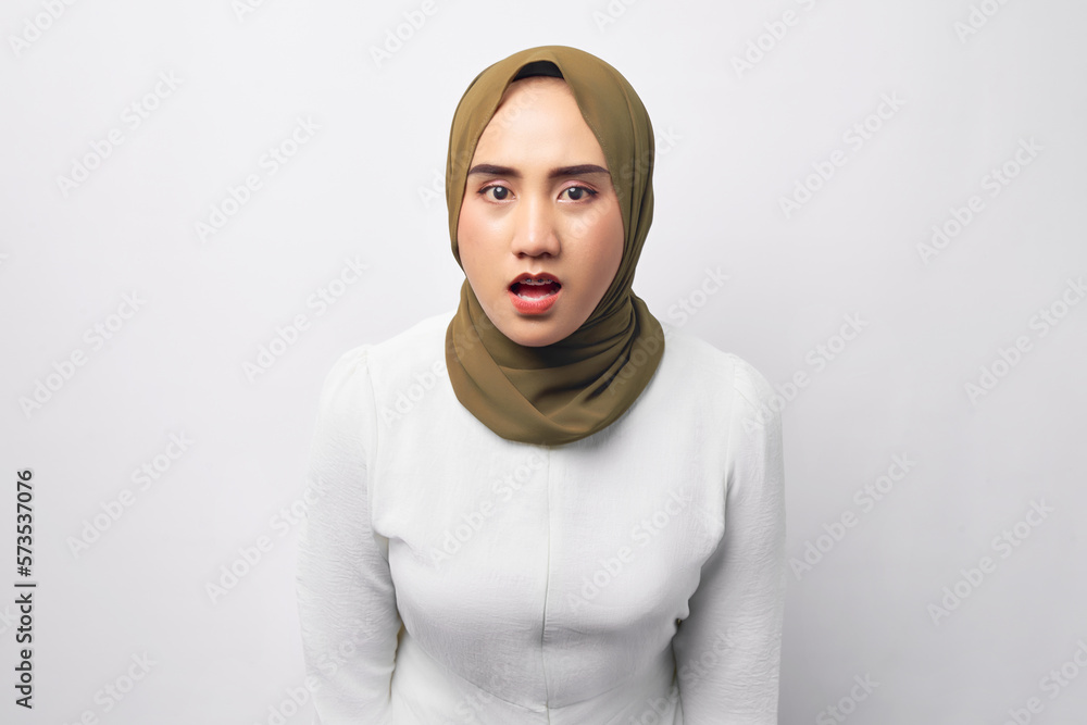 Shocked young beautiful Asian Muslim woman 20s wearing hijab looking at the camera with opened mouth isolated on white background. People religious lifestyle concept Shocked young beautiful Asian Muslim woman 20s wearing hijab looking at the camera with opened mouth isolated on white background. People religious lifestyle concept