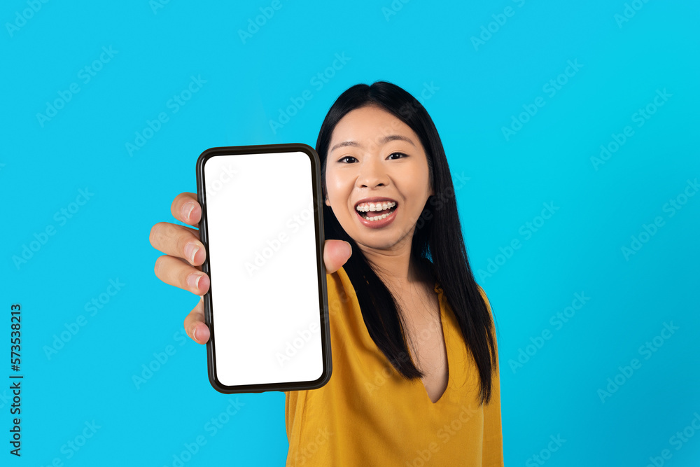 Beautiful asian woman showing smartphone with blank screen Beautiful asian woman showing smartphone with blank screen