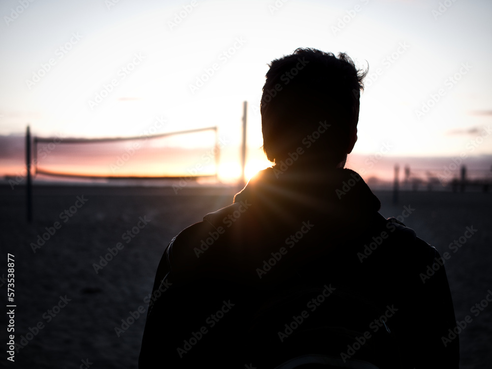 Silhouette of man standing against sundown sky