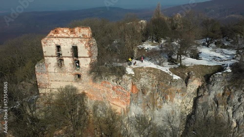 Tourists are walking around the ruins of Pajstun Castle, Slovakia aerial footage photo