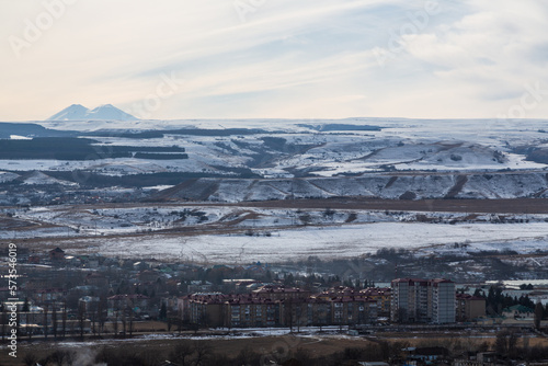 View over the countryside and volcano Elbrus from Mountain Ring in Kislovodsk, Stavropol Krai, Russia. Landscape of picturesque rock and sky in winter in Caucasus Mineral Waters